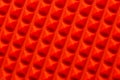 Abstract red silicone pyramids array close-up background