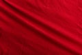 Abstract red textile background. Scarlet pleated fabric