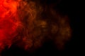 Abstract red and yellow smoke hookah on a black background. Royalty Free Stock Photo