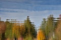 Abstract reflection of autumn colored trees into lake moving water Royalty Free Stock Photo