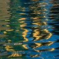 Abstract reflection on water, featuring a blend of shimmering blue and golden hues. The surface Royalty Free Stock Photo