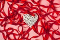 Abstract romantic background. White wicker heart, red ribbon on the pink background. Women`s day, mother day, valentines day,