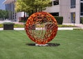 Abstract round orange painted metal sculpture in the Telecom Corridor in Richardson, Texas.