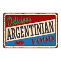 Abstract rusty plate or label with the text delicious Argentinian food written inside, traditional vintage food label