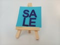 Abstract sale sign on a wood easel on a white background Royalty Free Stock Photo