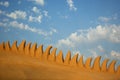 An abstract sand sculpture, a dragon crest against cloudy blue sky at the famous sand festival Fiesa in Algarve