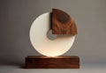 Abstract Circular Sculpture with Textured Wood Base and Warm Illumination Against Neutral Background Royalty Free Stock Photo