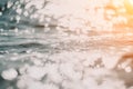 Abstract sea summer ocean sunset nature background. Small waves on golden water surface in motion blur with golden bokeh Royalty Free Stock Photo