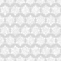 Abstract seamless pattern. It consists of snowflakes, evenly located on a gray background.