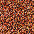 Abstract seamless pattern featuring a dense field of variegated small circles in warm tones against a deep navy blue background Royalty Free Stock Photo