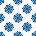 Abstract seamless pattern with stylized blue flowers on a white background. Royalty Free Stock Photo