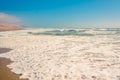 Sandy beach, ocean waves, and clear blue sky on background Royalty Free Stock Photo