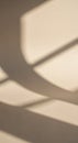 Abstract shadows on a beige surface create a dynamic pattern. Soft, curved and Royalty Free Stock Photo