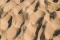 Abstract shapes from footprints in the sand for a summer beach background Royalty Free Stock Photo
