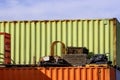 Abstract shipping containers with junk piled around them Royalty Free Stock Photo