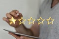 Abstract shot of a man showing 3D rendered golden rating stars with a 1-star rank