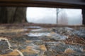 Abstract shot of wet flagstones under a park bench