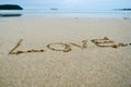 Abstract sign of word love written on a sand beach background Royalty Free Stock Photo