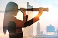 Abstract silhouette of businesswoman with telescope looking into the distance on bright city background with mock up place. Future Royalty Free Stock Photo