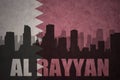 abstract silhouette of the city with text Al Rayyan at the vintage qatar flag