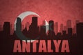 abstract silhouette of the city with text Antalya at the vintage turkish flag