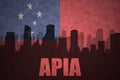 Abstract silhouette of the city with text Apia at the vintage Samoa flag