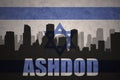 Abstract silhouette of the city with text Ashdod at the vintage israel flag