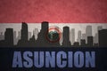 Abstract silhouette of the city with text Asuncion at the vintage paraguayan flag