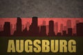 Abstract silhouette of the city with text Augsburg at the vintage german flag