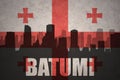 Abstract silhouette of the city with text Batumi at the vintage georgian flag