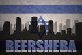 Abstract silhouette of the city with text Beersheba at the vintage israel flag