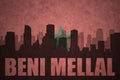 Abstract silhouette of the city with text Beni Mellal at the vintage moroccan flag