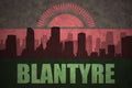 Abstract silhouette of the city with text Blantyre at the vintage malawi flag
