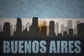 Abstract silhouette of the city with text Buenos Aires at the vintage argentinean flag