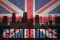 Abstract silhouette of the city with text Cambridge at the vintage british flag Royalty Free Stock Photo