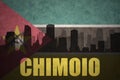 Abstract silhouette of the city with text Chimoio at the vintage mozambican flag