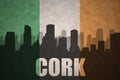 Abstract silhouette of the city with text Cork at the vintage irish flag