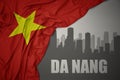 Abstract silhouette of the city with text Da Nang near waving national flag of vietnam on a gray background.3D illustration Royalty Free Stock Photo