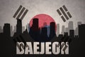 Abstract silhouette of the city with text Daejeon at the vintage south korea flag