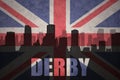 Abstract silhouette of the city with text Derby at the vintage british flag Royalty Free Stock Photo