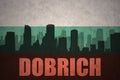 Abstract silhouette of the city with text Dobrich at the vintage bulgarian flag