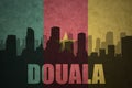 Abstract silhouette of the city with text Douala at the vintage cameroon flag