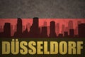 Abstract silhouette of the city with text Dusseldorf at the vintage german flag