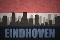 Abstract silhouette of the city with text Eindhoven at the vintage dutch flag