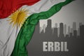Abstract silhouette of the city with text Erbil near waving national flag of kurdistan on a gray background.3D illustration