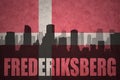 Abstract silhouette of the city with text Frederiksberg at the vintage danish flag