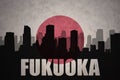 Abstract silhouette of the city with text Fukuoka at the vintage japanese flag