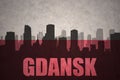 Abstract silhouette of the city with text Gdansk at the vintage polish flag