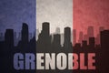 Abstract silhouette of the city with text Grenoble at the vintage french flag