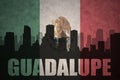 Abstract silhouette of the city with text Guadalupe at the vintage mexican flag